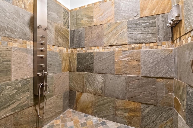 interior details with a tile shower