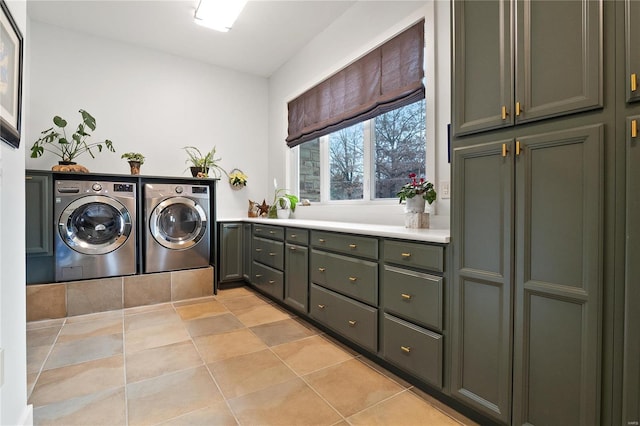 washroom with cabinets, washer and clothes dryer, and light tile patterned flooring