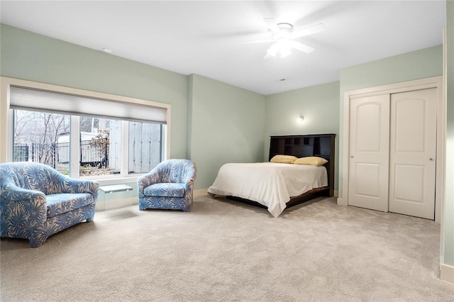 bedroom with ceiling fan and light colored carpet