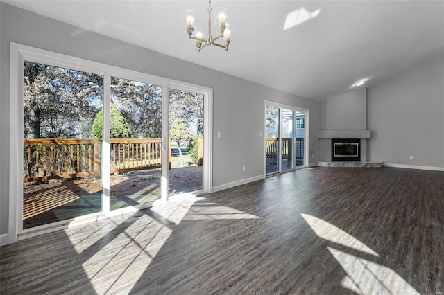 unfurnished living room with dark hardwood / wood-style flooring, lofted ceiling, and a notable chandelier