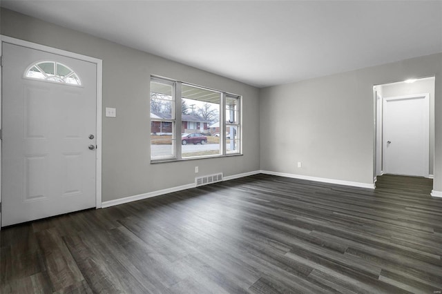 foyer with dark hardwood / wood-style flooring and a healthy amount of sunlight