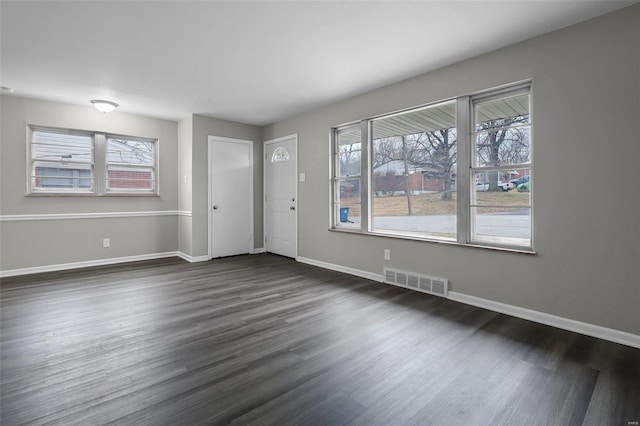 interior space with plenty of natural light and dark wood-type flooring