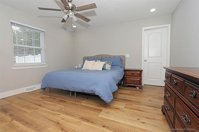 bedroom with ceiling fan and light wood-type flooring