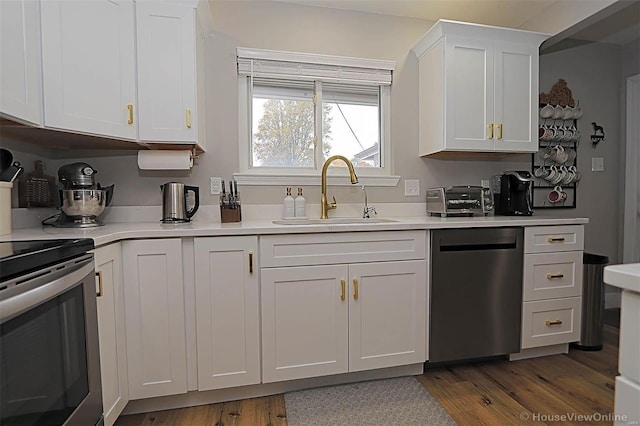 kitchen featuring white cabinetry, sink, dark hardwood / wood-style flooring, stainless steel dishwasher, and range with electric stovetop