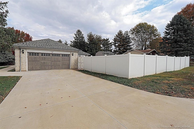 view of side of property featuring an outbuilding and a garage