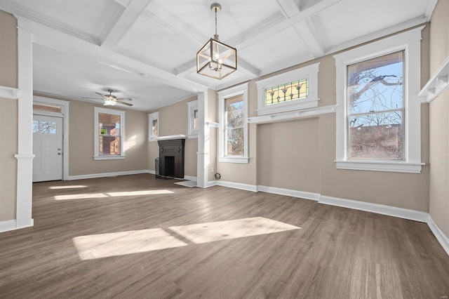 unfurnished living room featuring beamed ceiling, wood-type flooring, coffered ceiling, and a brick fireplace