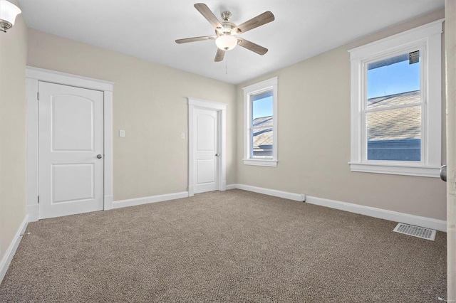 unfurnished bedroom featuring carpet flooring and ceiling fan