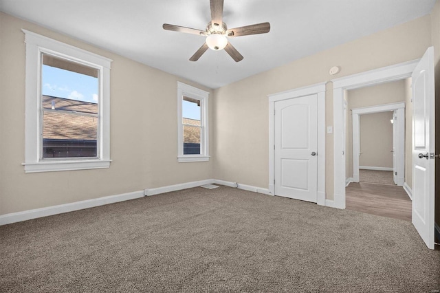 unfurnished bedroom with ceiling fan and carpet