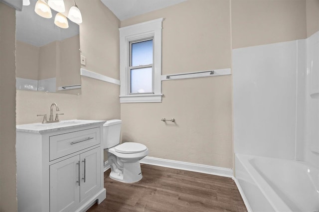 bathroom with wood-type flooring, vanity, and toilet