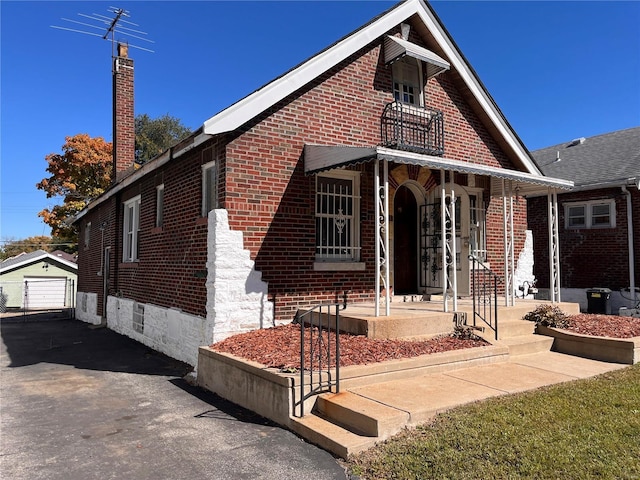 view of front facade featuring an outbuilding and a garage