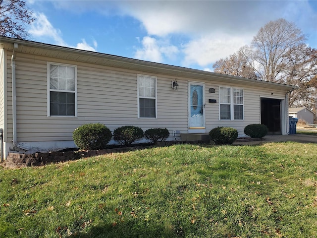 view of front of property featuring a garage and a front lawn