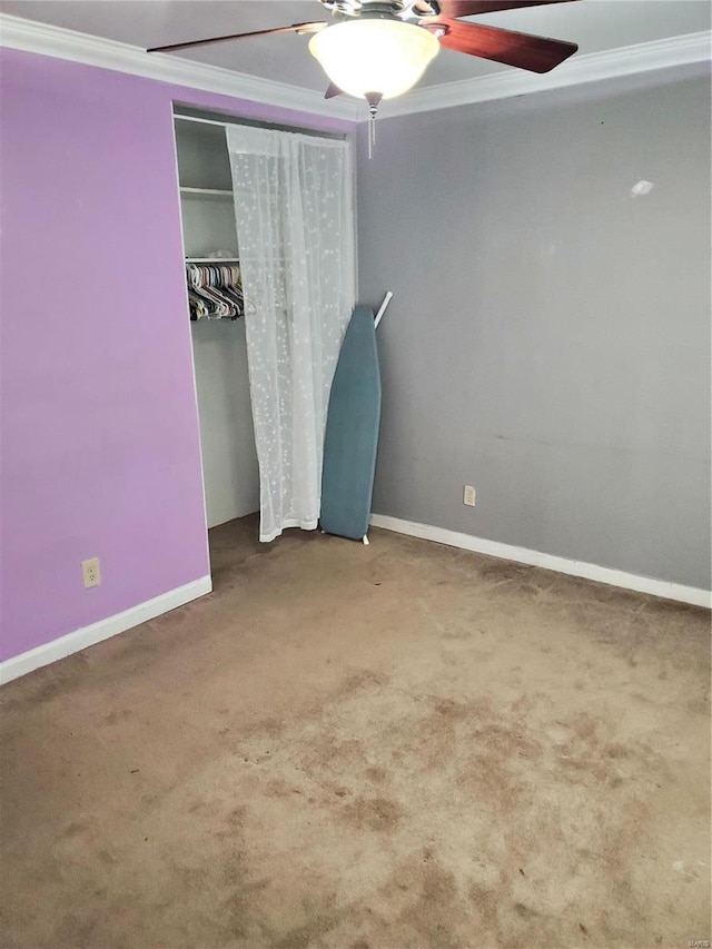 unfurnished bedroom with carpet, ceiling fan, ornamental molding, and a closet