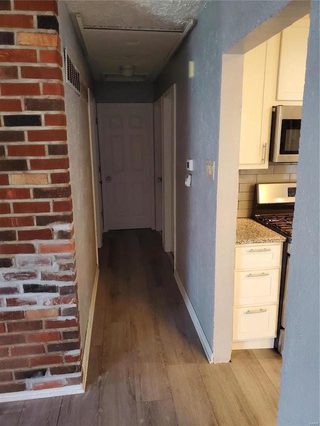 hall with light hardwood / wood-style floors