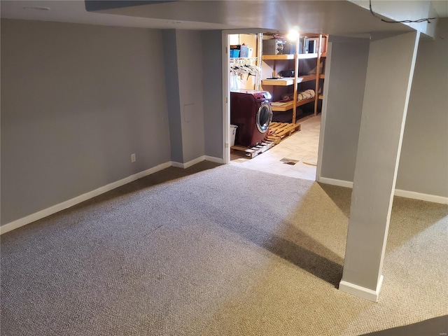 basement with carpet floors and washer / clothes dryer