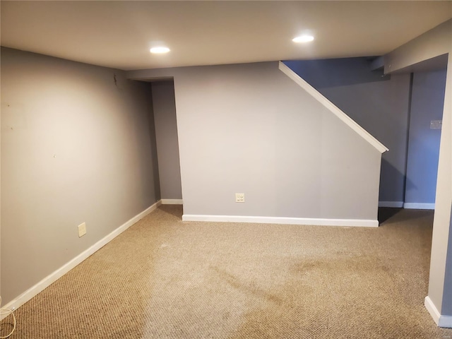 basement featuring light colored carpet