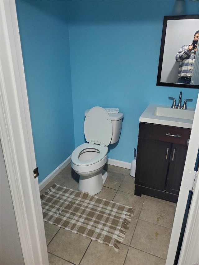 bathroom featuring tile patterned flooring, vanity, and toilet