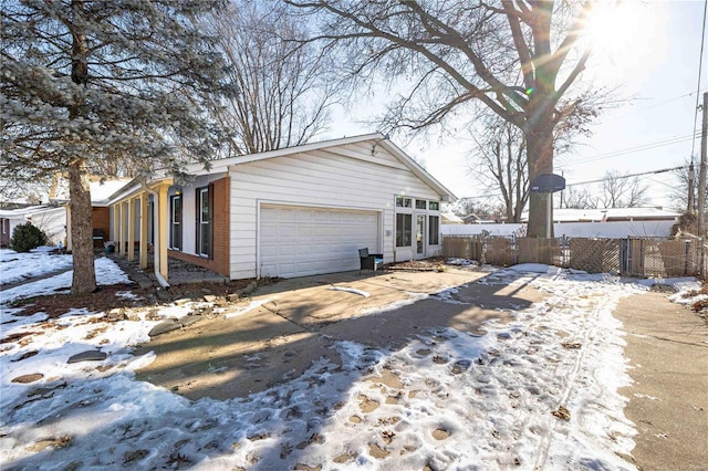 view of snowy exterior with a garage