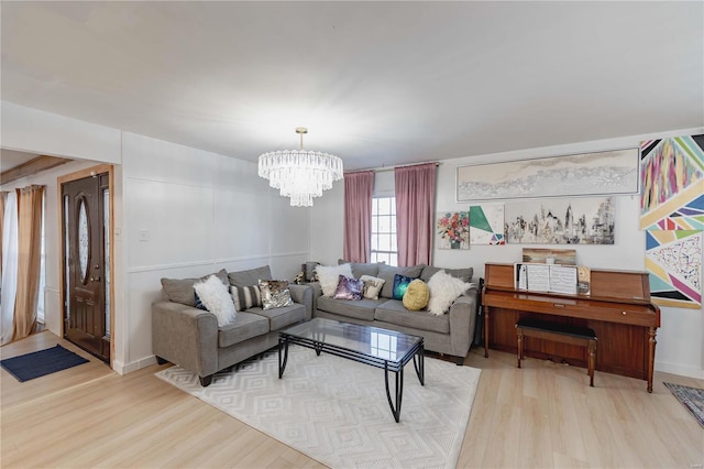 living room featuring a chandelier and light hardwood / wood-style flooring