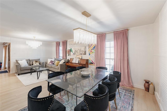 dining area with a chandelier and light hardwood / wood-style flooring