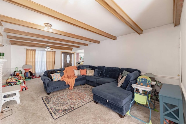 living room with carpet floors, ceiling fan, and beamed ceiling