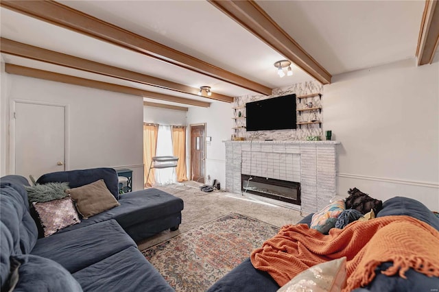 carpeted living room with beam ceiling