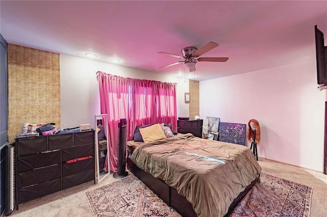 bedroom featuring ceiling fan and light carpet