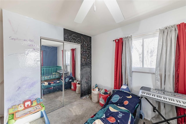 carpeted bedroom featuring a closet and ceiling fan