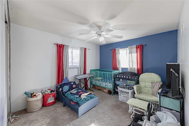 carpeted bedroom with multiple windows and ceiling fan