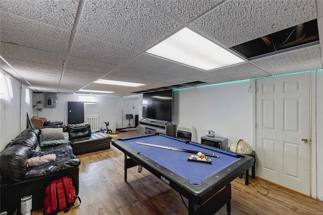 recreation room featuring hardwood / wood-style floors, electric panel, pool table, and a drop ceiling