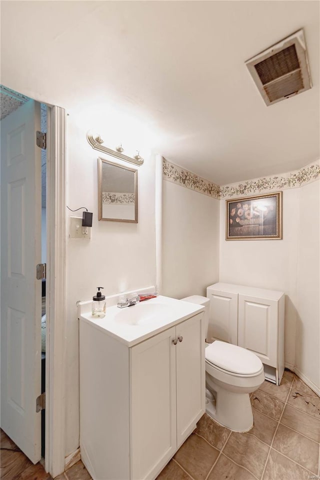 bathroom featuring toilet and vanity