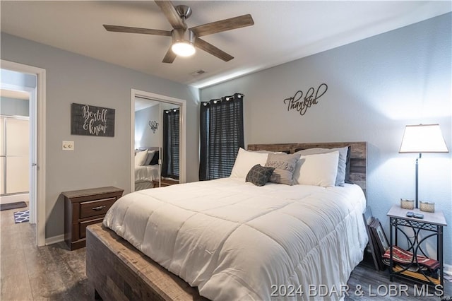 bedroom featuring dark hardwood / wood-style flooring, a closet, and ceiling fan