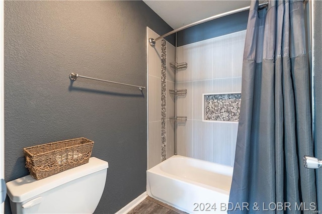 bathroom featuring shower / bath combo and toilet