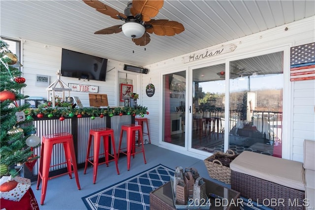 view of patio / terrace featuring ceiling fan and a bar