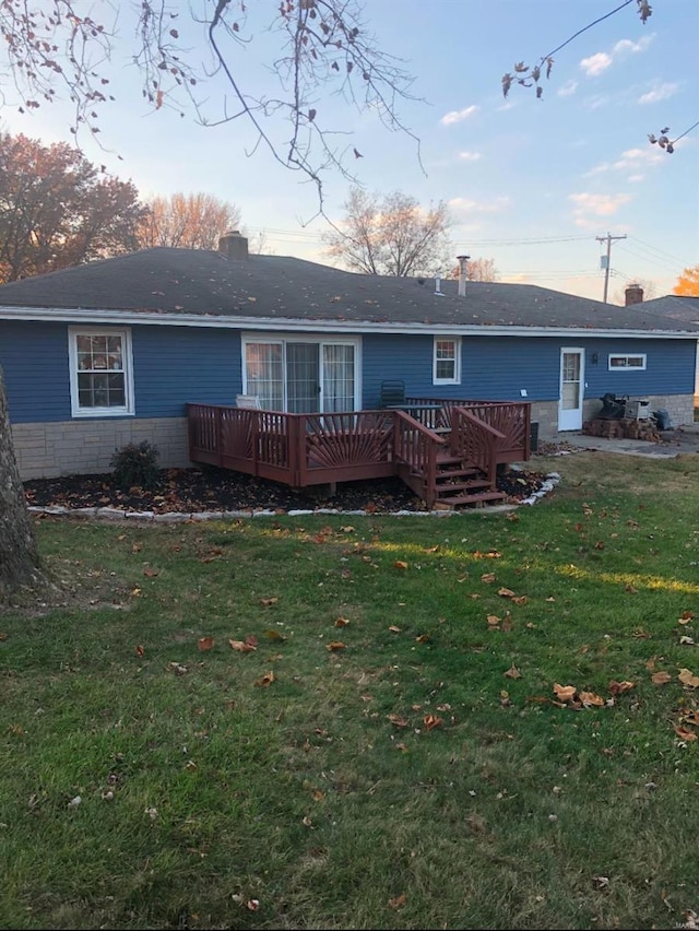 back of house with a lawn and a deck