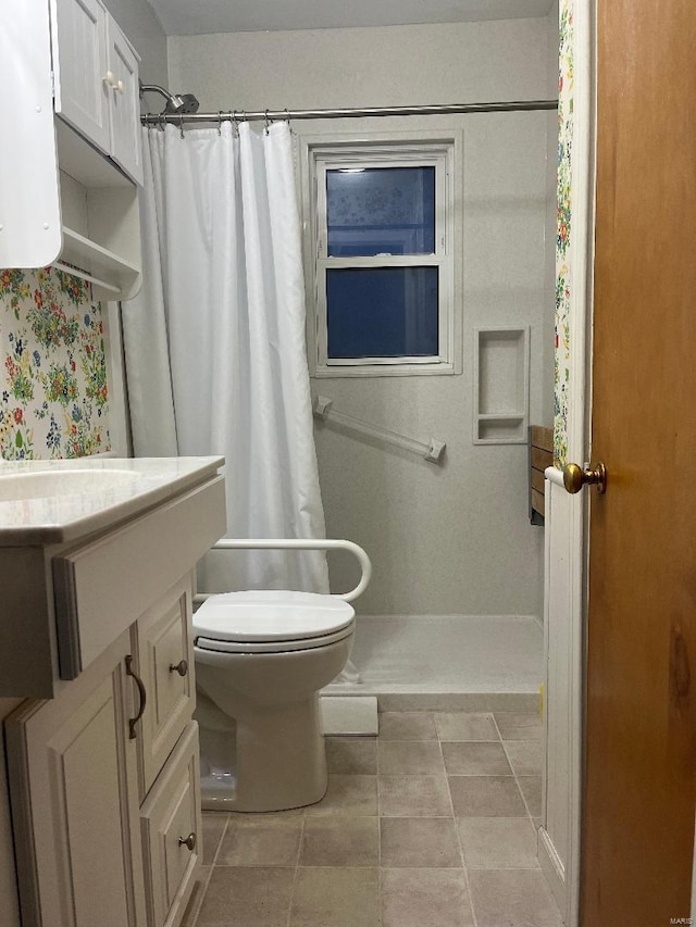 bathroom with vanity, curtained shower, and toilet