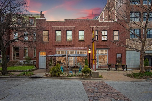 view of outdoor building at dusk