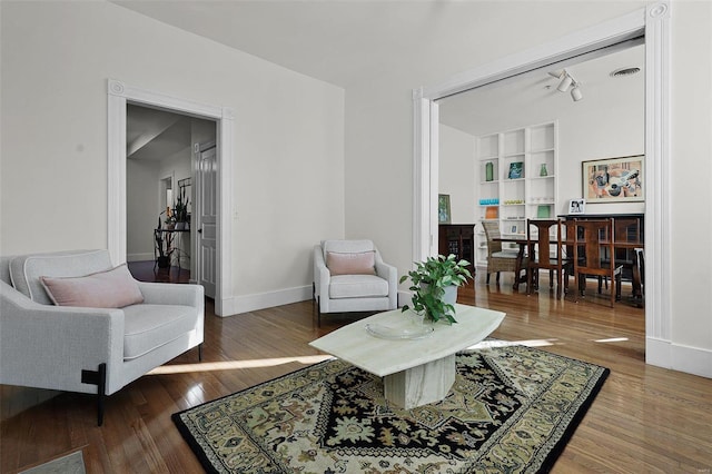 living room featuring hardwood / wood-style flooring and built in features