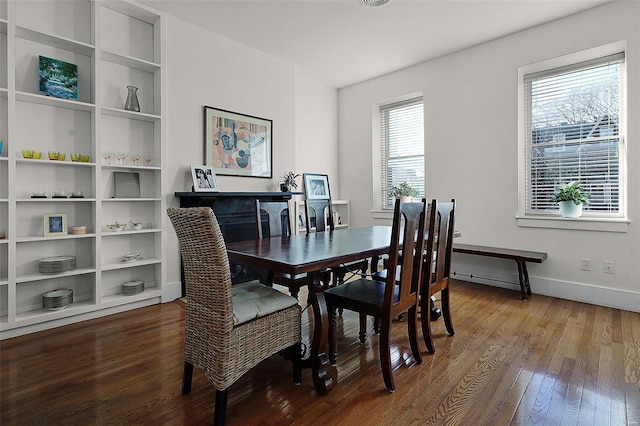 dining area with built in features and wood-type flooring