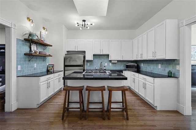 kitchen featuring a breakfast bar area, white cabinetry, and a kitchen island