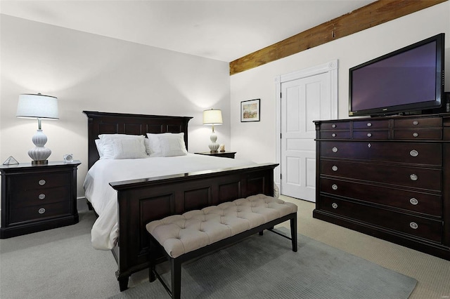 bedroom with beam ceiling and light carpet