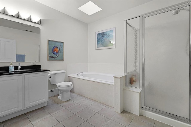 full bathroom with a skylight, plus walk in shower, tile patterned flooring, and vanity