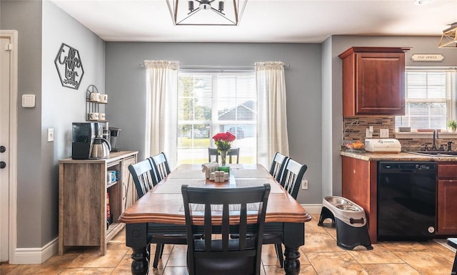 dining area featuring light tile patterned flooring, an inviting chandelier, and sink