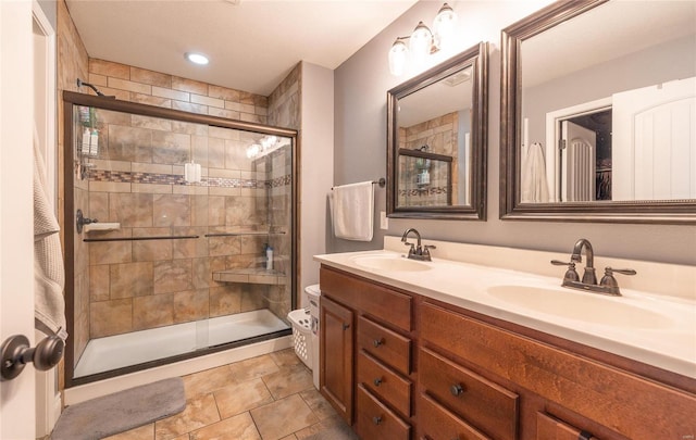 bathroom featuring vanity, toilet, and a shower with door