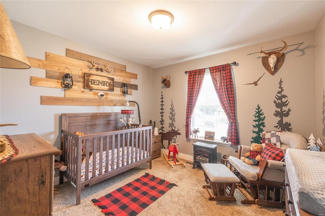 carpeted bedroom featuring a wood stove and a nursery area