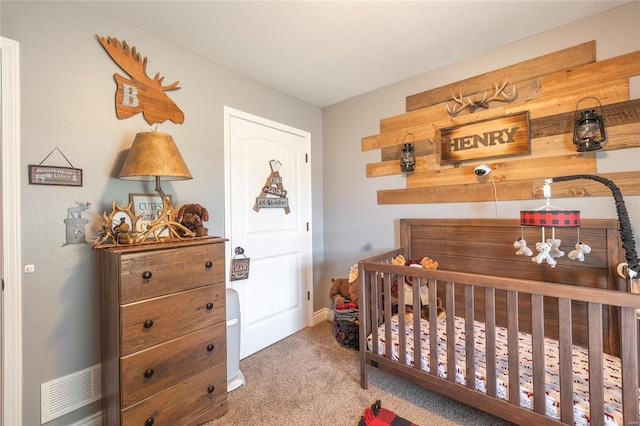 bedroom with carpet and a nursery area