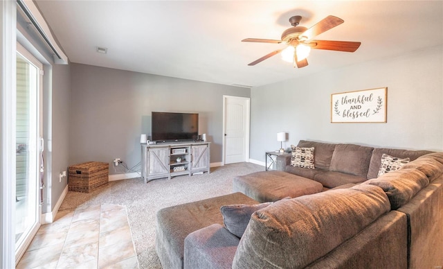 living room featuring ceiling fan and light colored carpet