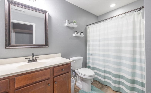 bathroom featuring tile patterned flooring, vanity, and toilet