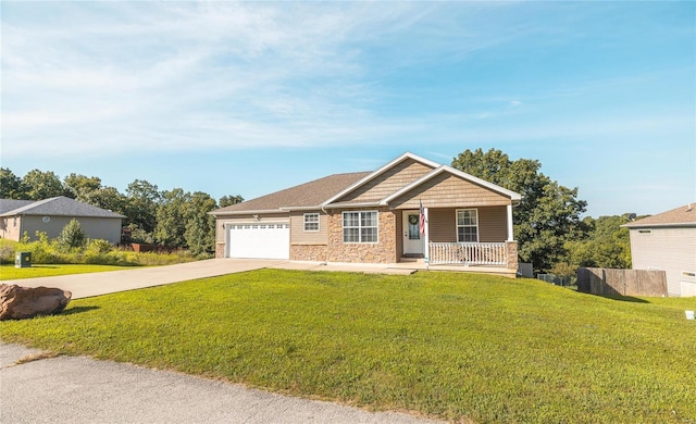 craftsman-style home with covered porch, a garage, and a front lawn