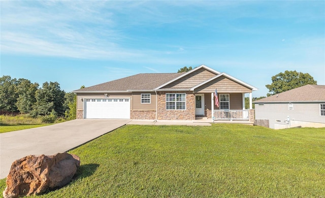 view of front of property with a porch, a garage, and a front lawn