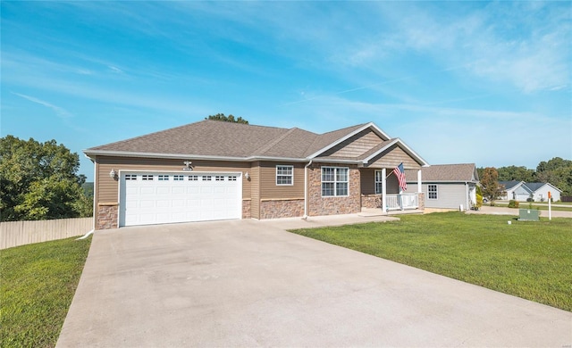 view of front of home featuring a front lawn, a porch, and a garage